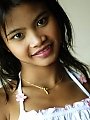 Innocent Thai teen posing on bed