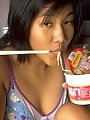 Asian girl drops noodles all over her hairy pussy...