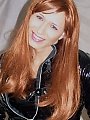 Redhead tranny in a vinyl dress and boots...